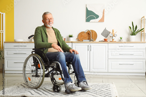 Senior man in wheelchair at home photo