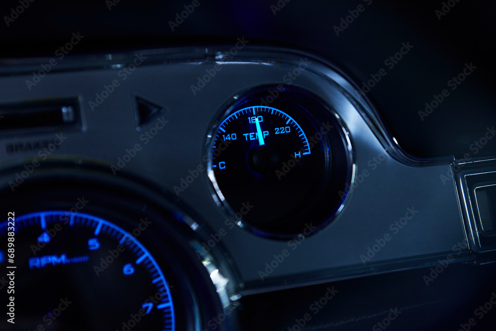 Dashboard of an illuminated sports car. Gas, oil, speed indicator. Dashboard of an illuminated sports car. Gas, oil, speed indicator.