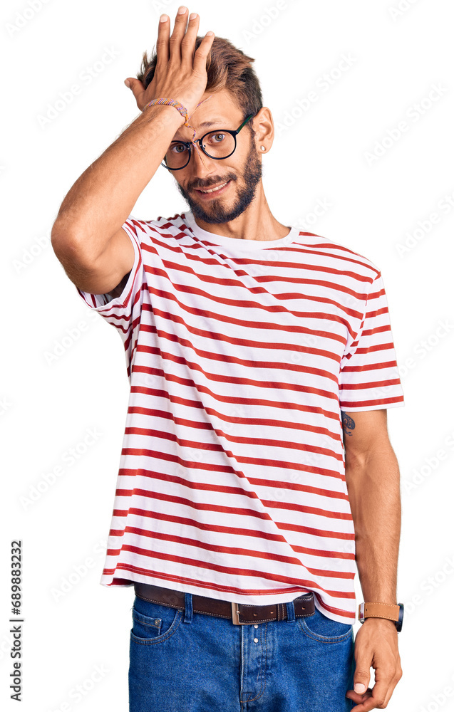 Handsome blond man with beard wearing casual clothes and glasses surprised with hand on head for mistake, remember error. forgot, bad memory concept. Handsome blond man with beard wearing casual clothes and glasses surprised with hand on head for mistake, remember error. forgot, bad memory concept.
