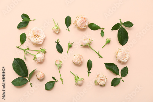Fototapeta Naklejka Na Ścianę i Meble -  Beautiful pink roses with leaves on beige background
