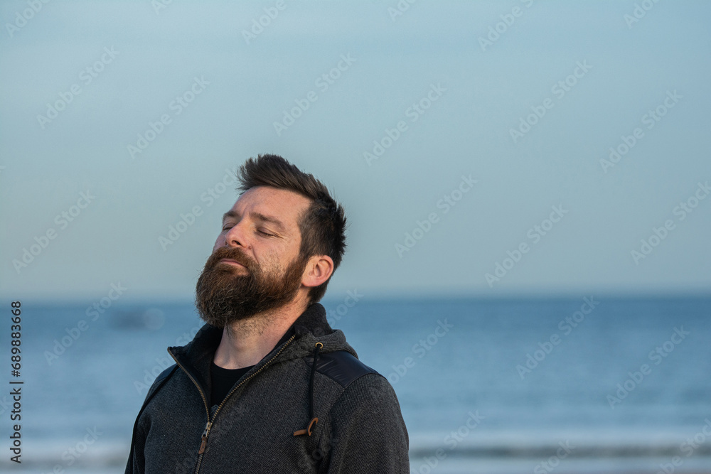 Handsome man at the beach.  Outdoor portrait of beautiful man.