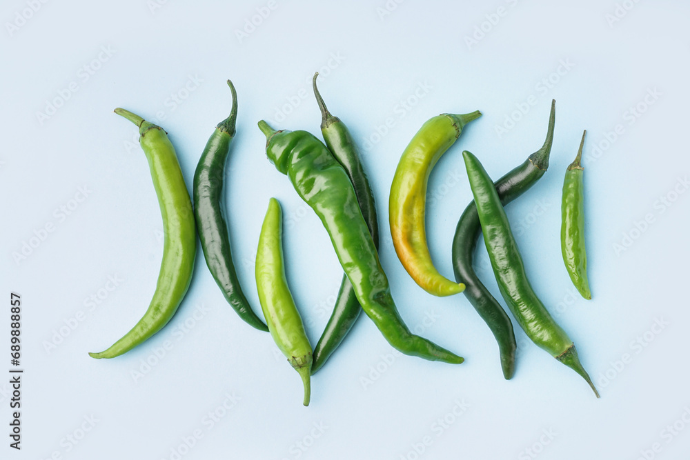 Green chili peppers on blue background Green chili peppers on blue background
