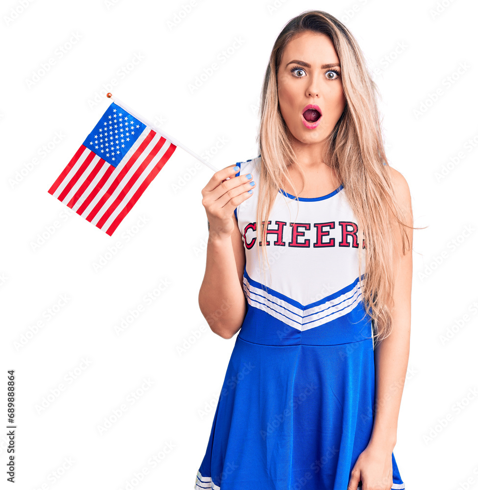 Φωτογραφία Young beautiful blonde woman wearing cheerleader uniform holding united states f