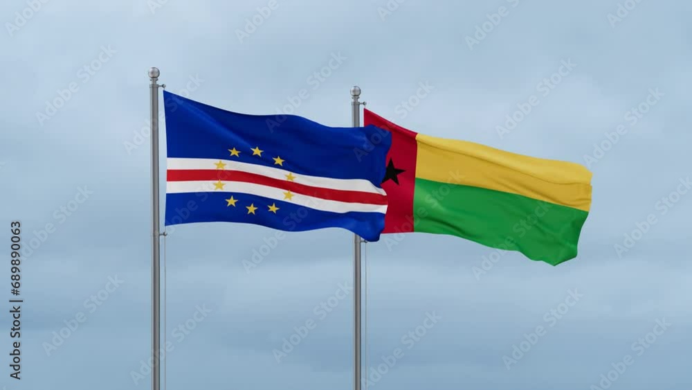 Guinea-Bissau flag and Cape Verde flag waving together on cloudy sky, endless seamless loop, two country relations concept Guinea-Bissau flag and Cape Verde flag waving together on cloudy sky, endless seamless loop, two country relations concept