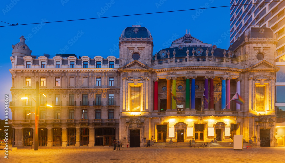 Evening photo of Vlaamse Opera, decorated with LGBTQ flags and illuminated by city lights. Flemish region of Belgium, Antwerp.