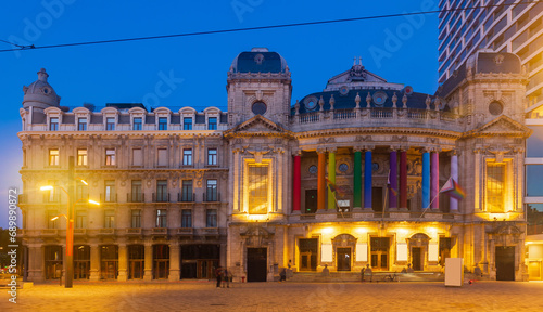 Evening photo of Vlaamse Opera, decorated with LGBTQ flags and illuminated by city lights. Flemish region of Belgium, Antwerp. photo