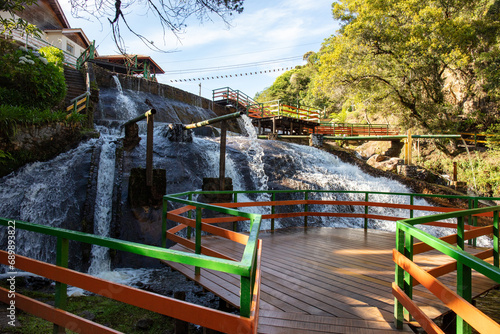 Tourists on outdoor adventure and natural waterfall Ducha de Plata (silver fall) in the Campos do Jordao mountains Serra da Mantigueira photo