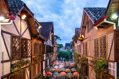 Swiss architecture in Campos do Jordão. Street with umbrella decorating cold tourist city of Sao Paulo at Christmas time in Brazil, window view photo