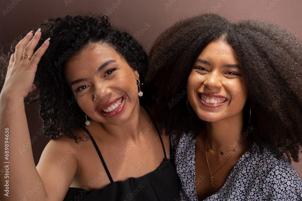 Half-closed portrait of two happy young friends. Friendship concept. Half-closed portrait of two happy young friends. Friendship concept.