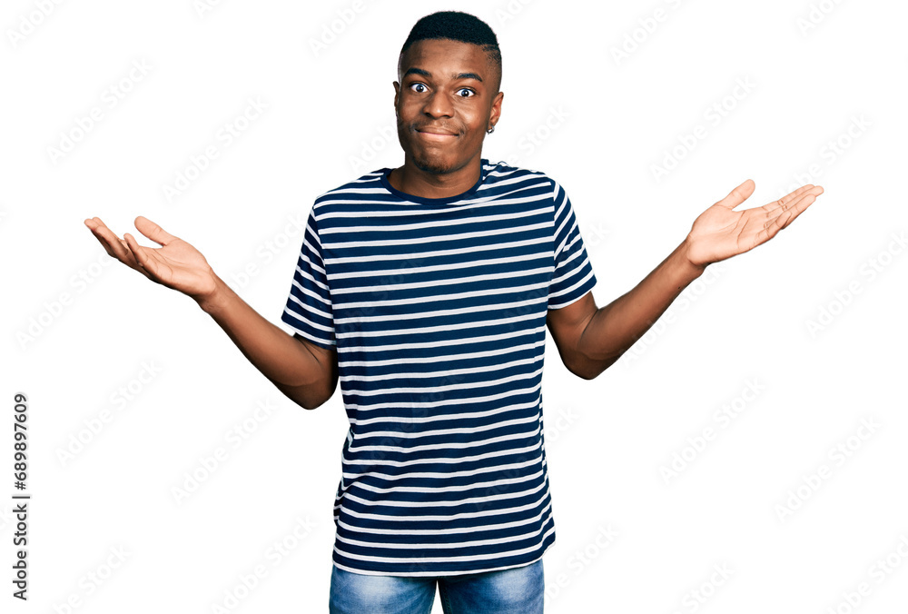 Φωτογραφία Young african american man wearing casual striped t shirt clueless and confused with open arms, no idea and doubtful face