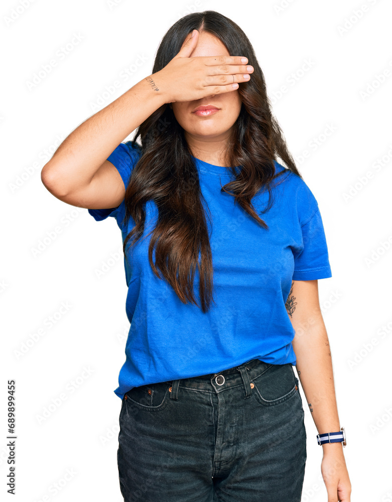 Fototapeta premium Beautiful brunette young woman wearing casual clothes covering eyes with hand, looking serious and sad. sightless, hiding and rejection concept