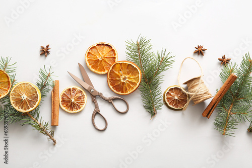Dried orange slices with fir branches, cinnamon and star anise on grey background
