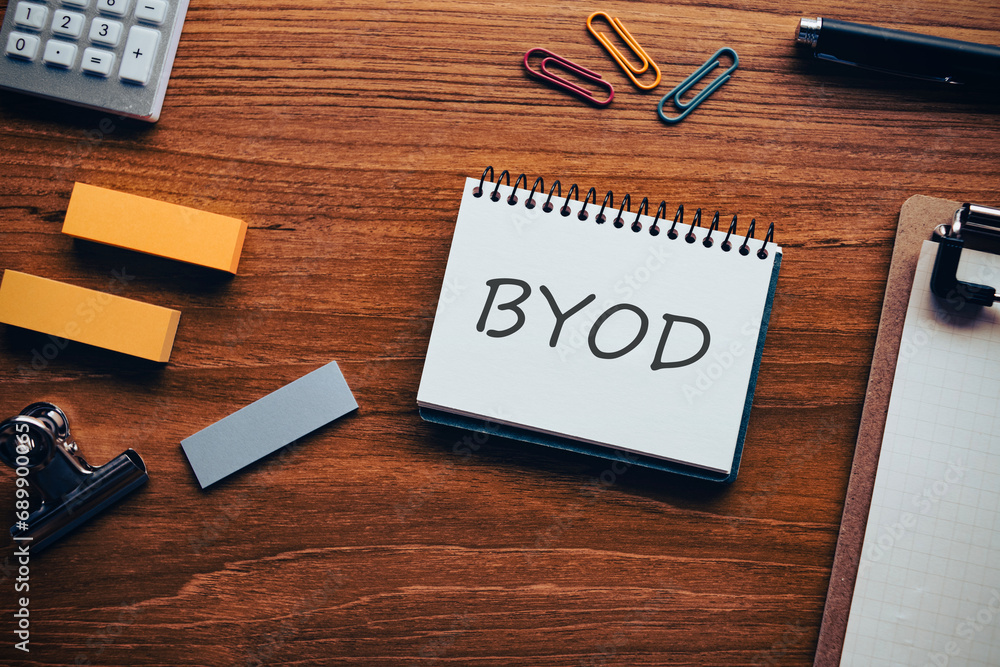 There is notebook with the word BYOD. It is an abbreviation for Bring Your Own Device as eye-catching image. There is notebook with the word BYOD. It is an abbreviation for Bring Your Own Device as eye-catching image.