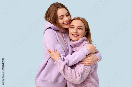Happy young woman hugging h...