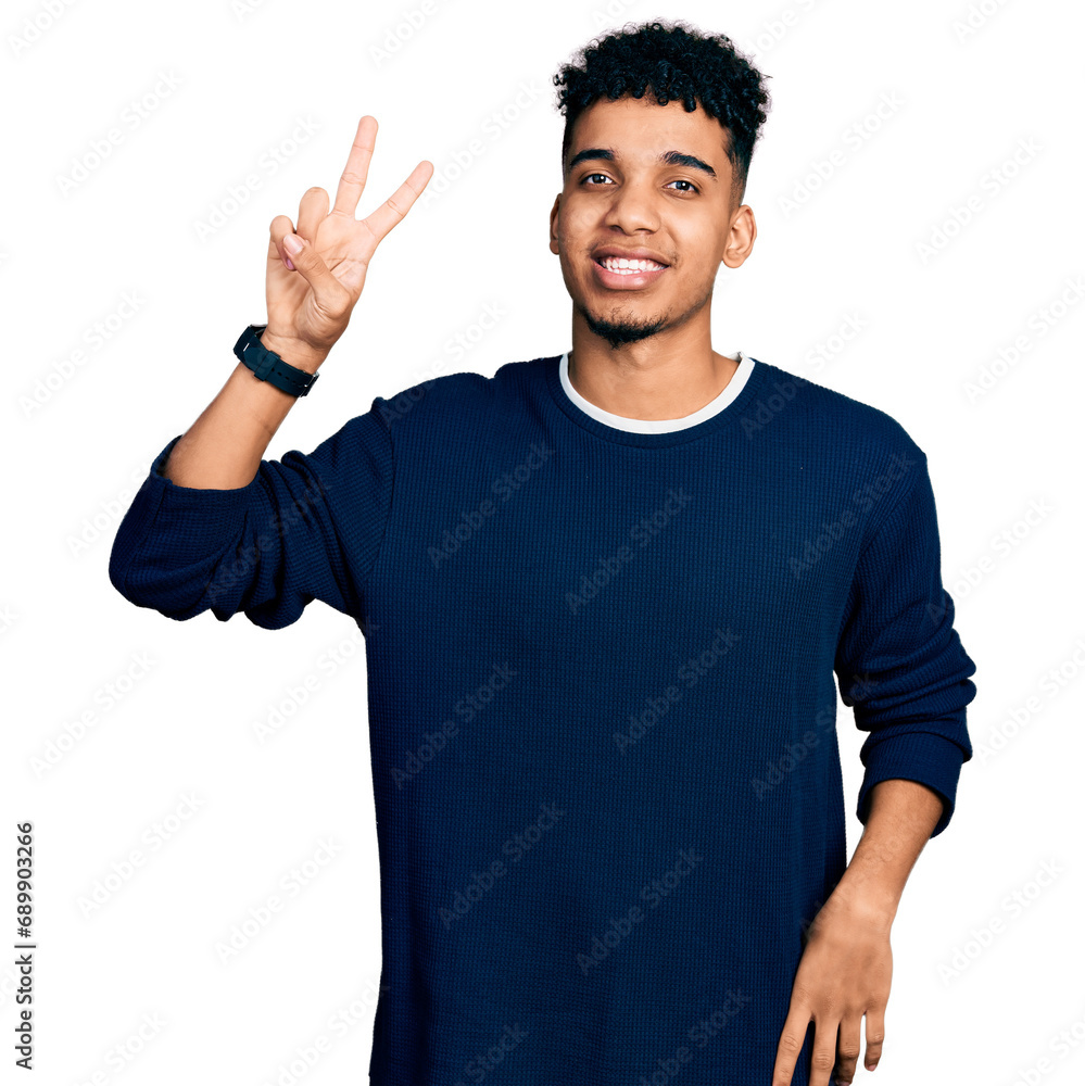 Naklejka premium Young african american man wearing casual clothes showing and pointing up with fingers number two while smiling confident and happy.