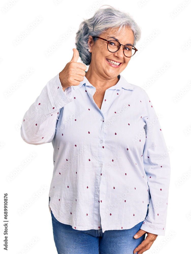 Senior woman with gray hair wearing casual business clothes and glasses smiling happy and positive, thumb up doing excellent and approval sign Senior woman with gray hair wearing casual business clothes and glasses smiling happy and positive, thumb up doing excellent and approval sign