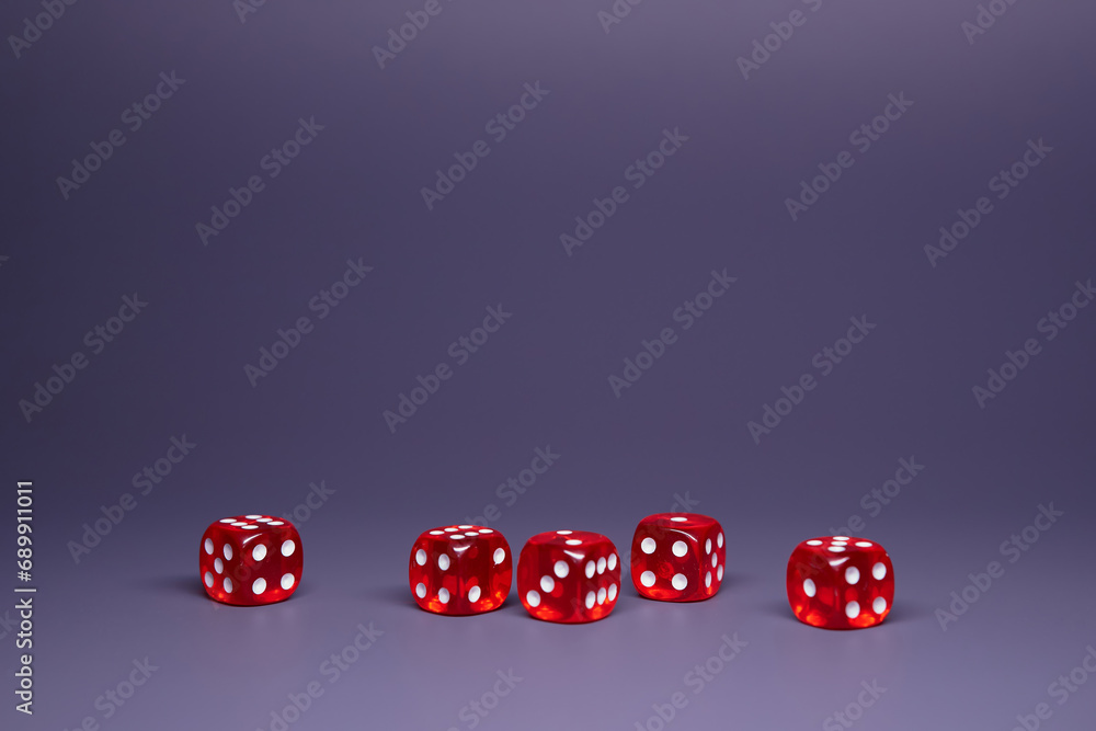 Red dices on grey background. Copy space.