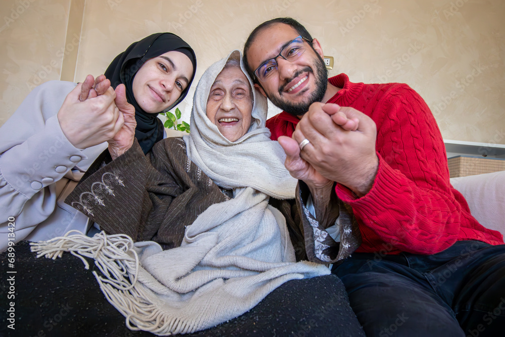 mother father and grandmother as a happy family in modern living room