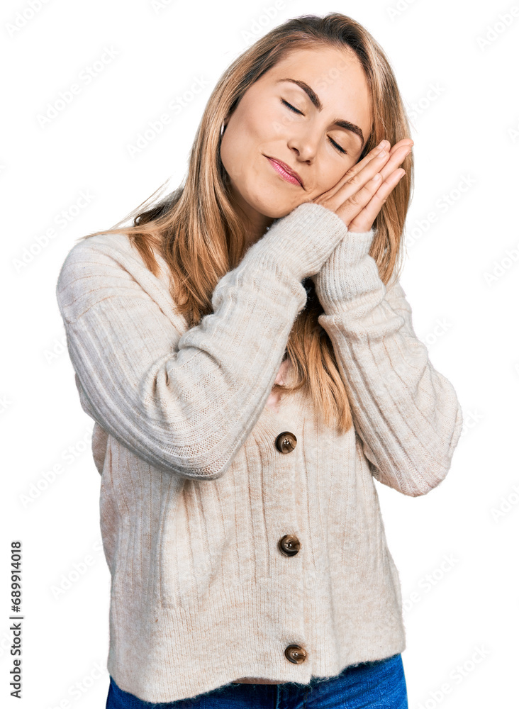 Young blonde woman wearing casual clothes sleeping tired dreaming and posing with hands together while smiling with closed eyes. Young blonde woman wearing casual clothes sleeping tired dreaming and posing with hands together while smiling with closed eyes.