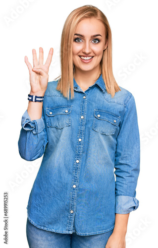 Beautiful caucasian woman wearing casual denim jacket showing and pointing up with fingers number four while smiling confident and happy.