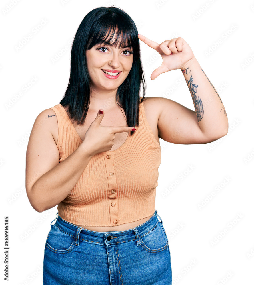 Young hispanic plus size woman wearing casual clothes smiling making frame with hands and fingers with happy face. creativity and photography concept. Young hispanic plus size woman wearing casual clothes smiling making frame with hands and fingers with happy face. creativity and photography concept.