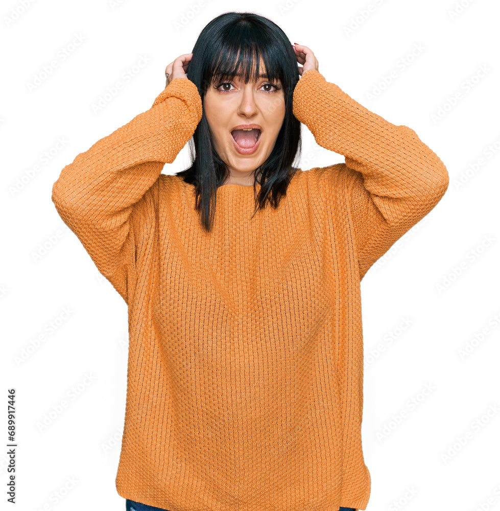 Young hispanic woman wearing casual clothes crazy and scared with hands on head, afraid and surprised of shock with open mouth Young hispanic woman wearing casual clothes crazy and scared with hands on head, afraid and surprised of shock with open mouth