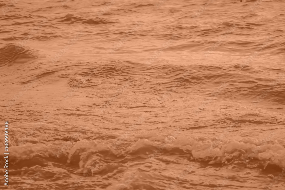 Peach Fuzz toned sea water texture. Pool water with sun reflections. Trendy colour 2024 year. Peach Fuzz toned sea water texture. Pool water with sun reflections. Trendy colour 2024 year.