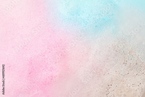 Colorful foam after dissolving bath bomb in water, closeup photo