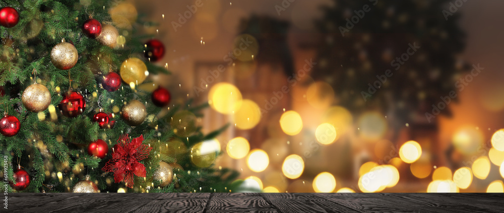 Christmas tree decorated with red and golden balls near wooden table indoors. Banner design with space for text Christmas tree decorated with red and golden balls near wooden table indoors. Banner design with space for text