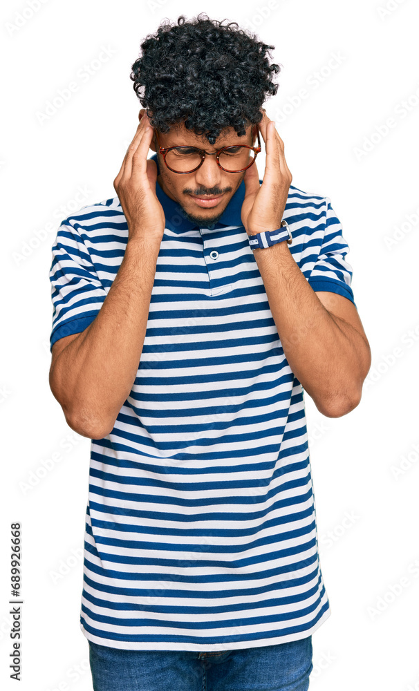 Young arab man wearing casual clothes and glasses with hand on head for pain in head because stress. suffering migraine. Young arab man wearing casual clothes and glasses with hand on head for pain in head because stress. suffering migraine.