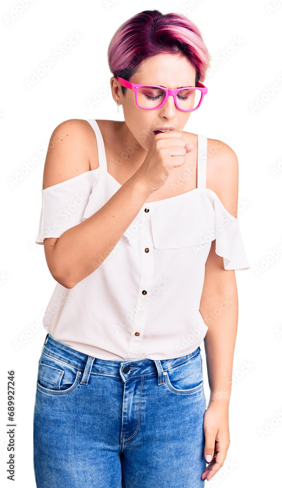 Young beautiful woman with pink hair wearing casual clothes and glasses feeling unwell and coughing as symptom for cold or bronchitis. health care concept. Young beautiful woman with pink hair wearing casual clothes and glasses feeling unwell and coughing as symptom for cold or bronchitis. health care concept.