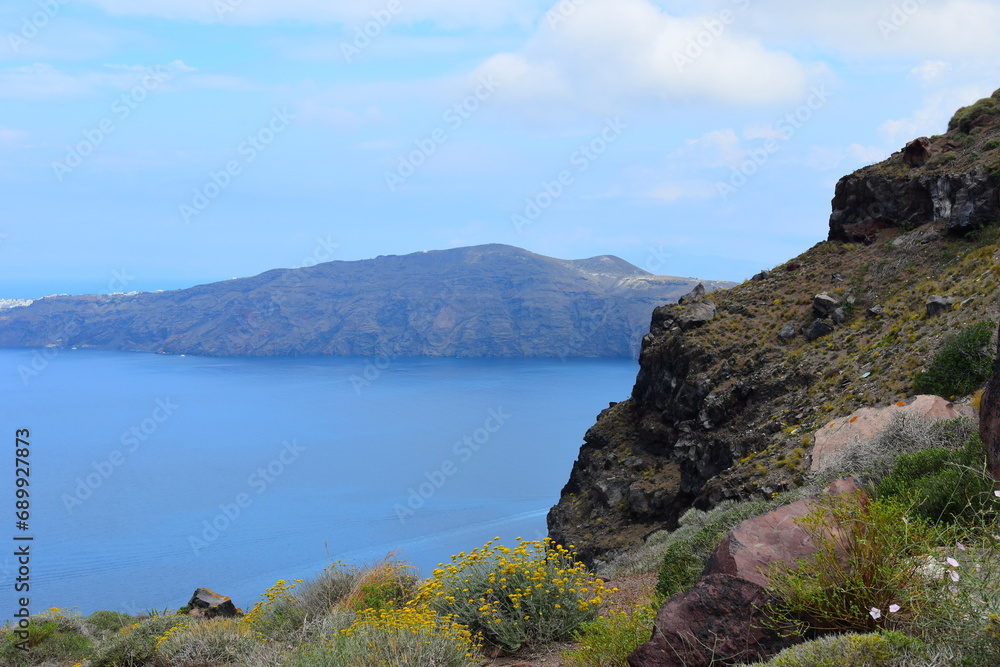 View of Skaros rock, a rocky headland that protrudes out to the azure blue Aegean Sea, Imerovigli, Santorini, Greece. This was on a hot sunny afternoon.
