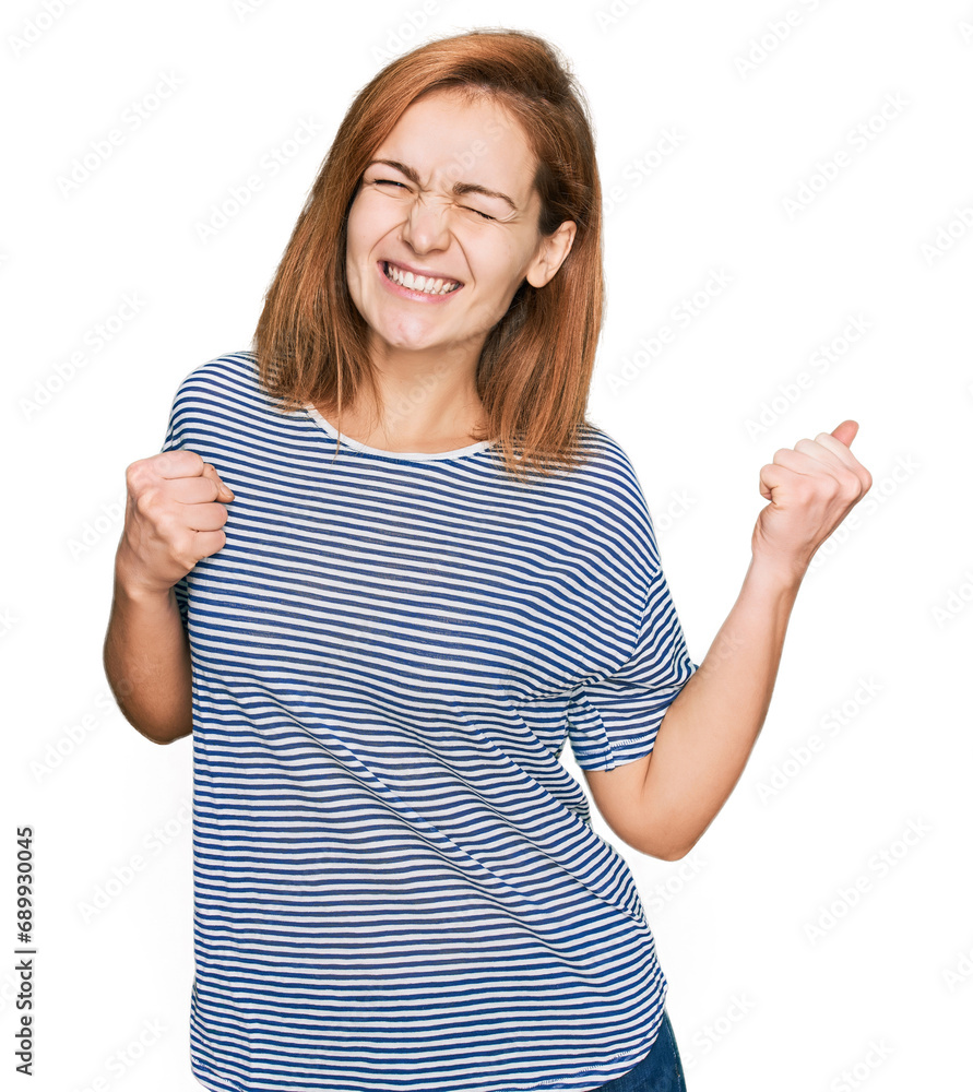 Young caucasian woman wearing casual clothes excited for success with arms raised and eyes closed celebrating victory smiling. winner concept. Young caucasian woman wearing casual clothes excited for success with arms raised and eyes closed celebrating victory smiling. winner concept.