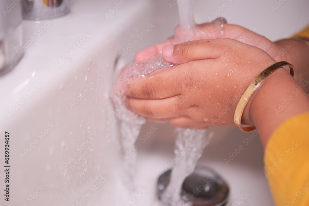 child washing hands with soap 