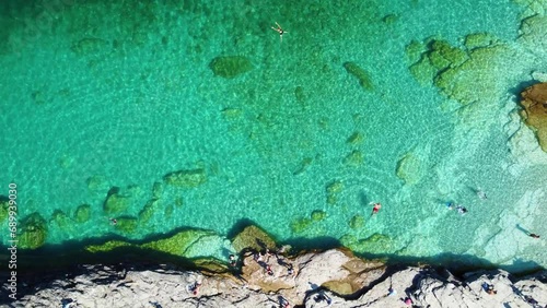 Top View Of Tourists Swimming On Turquoise Beach Of Flowerpot Island, Georgian Bay, Ontario, Canada. Aerial Shot photo