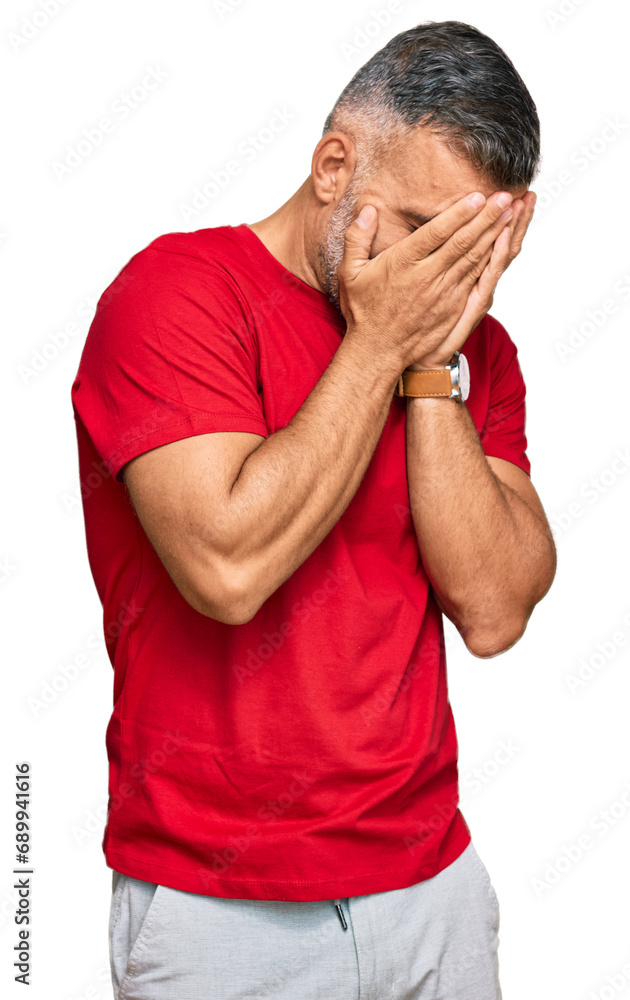 Middle age handsome man wearing casual clothes with sad expression covering face with hands while crying. depression concept. Middle age handsome man wearing casual clothes with sad expression covering face with hands while crying. depression concept.