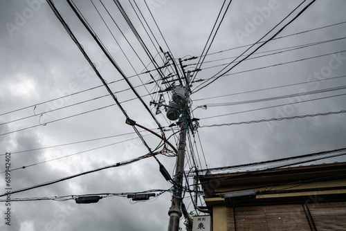 Power lines and transistors on an electricity pilon in Kyoto, Japan