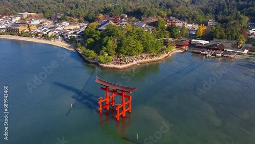 Japanese traditional red torii gate at sea, floating torii of Miyajima island in Hiroshima, tourism in Japan, Japanese culture