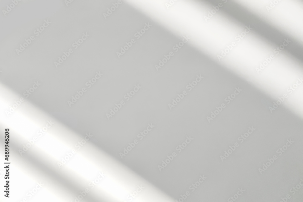 Gray shadow and light blur abstract background on white wall from window. Dark stripe grey shadows indoor in room background, monochrome, shadow overlay effect for backdrop and mockup design Gray shadow and light blur abstract background on white wall from window. Dark stripe grey shadows indoor in room background, monochrome, shadow overlay effect for backdrop and mockup design