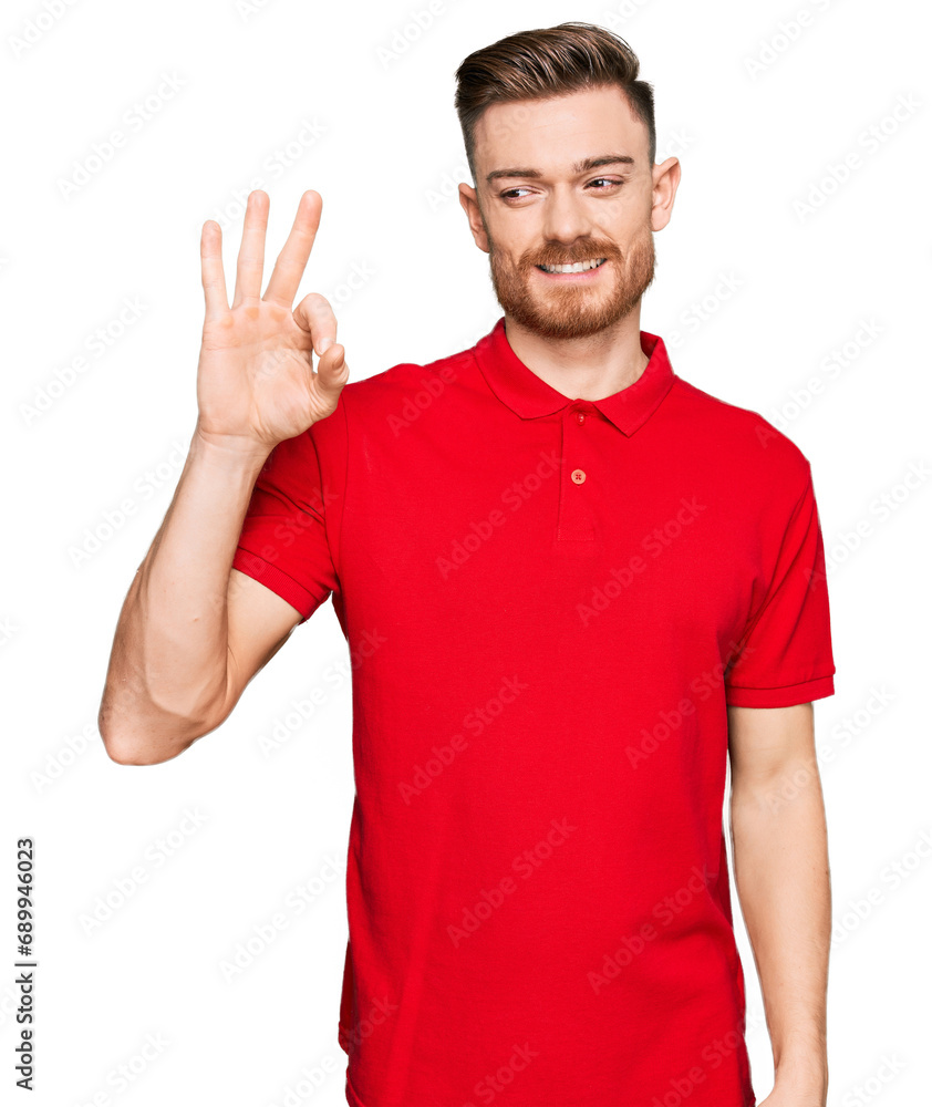 Young redhead man wearing casual clothes smiling positive doing ok sign with hand and fingers. successful expression. Young redhead man wearing casual clothes smiling positive doing ok sign with hand and fingers. successful expression.