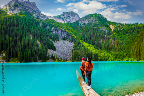 Joffre Lakes British Colombia Whistler Canada, Joffre Lakes National Park in Canada. A couple of women and men walking at Jofre Lake BC Canada an emerald green turqouse colored lake with mountains photo