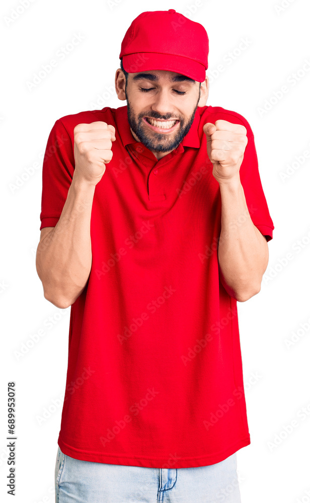 Young handsome man with beard wearing delivery uniform excited for success with arms raised and eyes closed celebrating victory smiling. winner concept. Young handsome man with beard wearing delivery uniform excited for success with arms raised and eyes closed celebrating victory smiling. winner concept.
