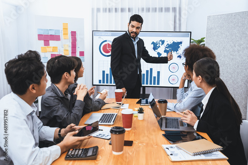 Businessman presenting data analysis dashboard display on TV screen in modern meeting for marketing strategy. Business presentation with group of business people in conference room. Concord