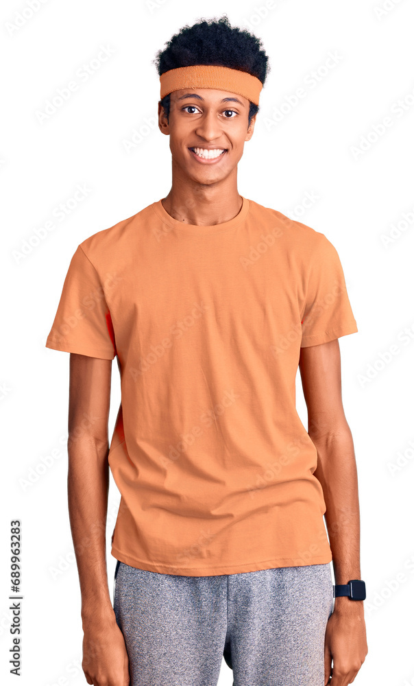 Young african american man wearing sportswear looking positive and happy standing and smiling with a confident smile showing teeth