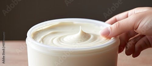 Using a cream to moisturize dry skin due to psoriasis, eczema, and other dry conditions. photo