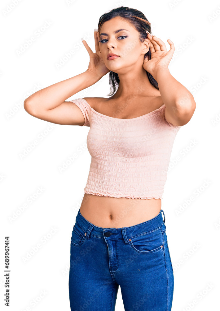 Young beautiful woman wearing casual clothes trying to hear both hands on ear gesture, curious for gossip. hearing problem, deaf Young beautiful woman wearing casual clothes trying to hear both hands on ear gesture, curious for gossip. hearing problem, deaf