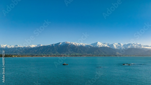 a large body of water with a mountain in the background © Stewart