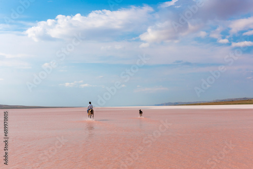 Horseback riding in the shallow waters of the salt lake, which turns pink in September, is very fun.