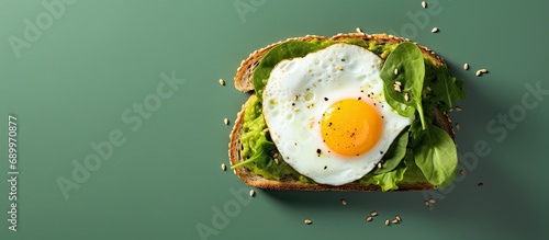 Avocado, spinach, and fried egg on toast, from above.