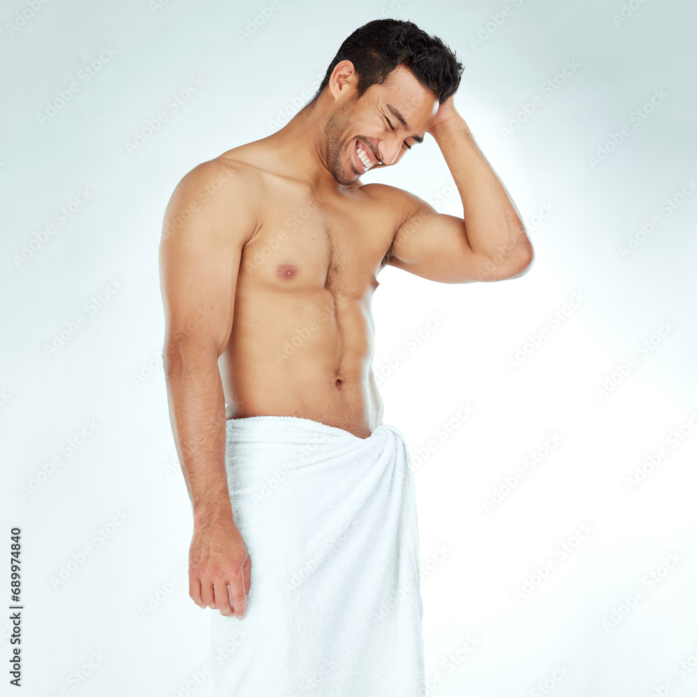 Fototapeta premium Cleaning, towel and happy fitness man in studio for wellness, hygiene or body care routine on white background. Shower, grooming or muscular Japanese male model with pamper, cosmetics or treatment